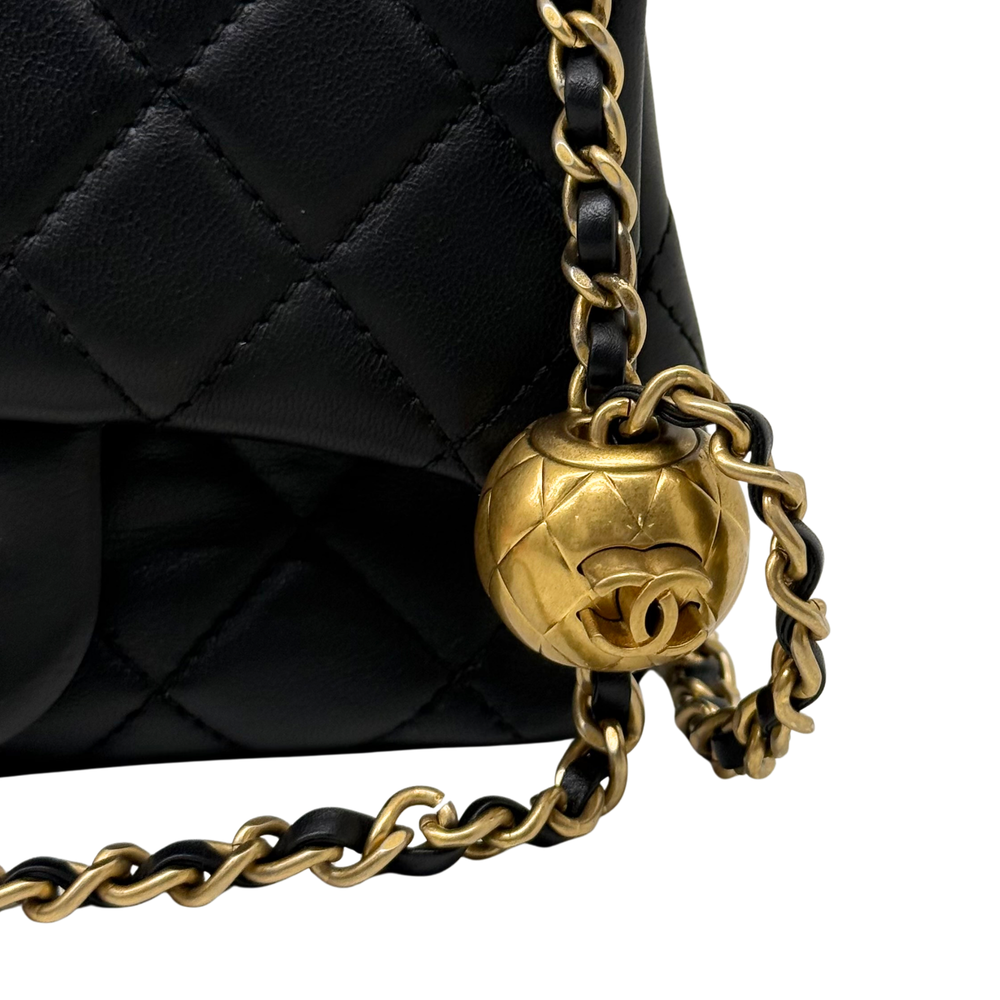 Gold-tone CC turn-lock and chain detail on black quilted flap shoulder bag