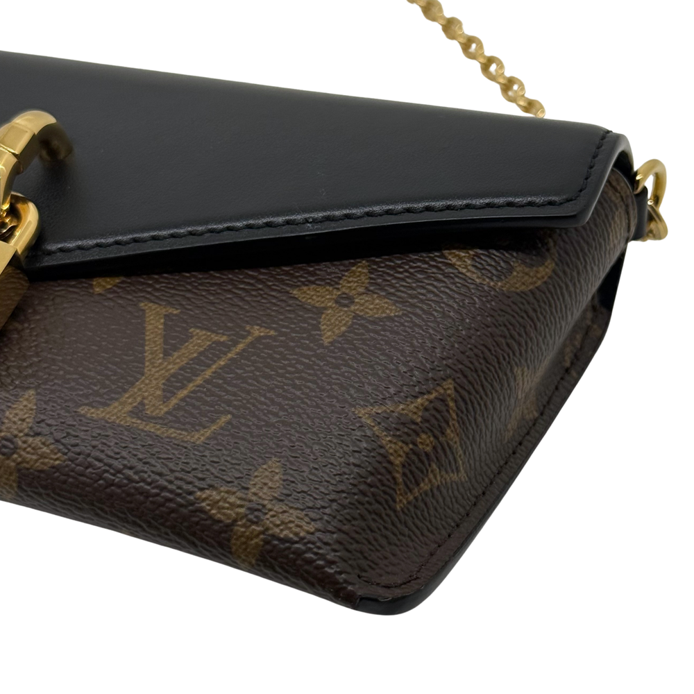 Black leather flap and brown monogram canvas corner with gold-tone hardware