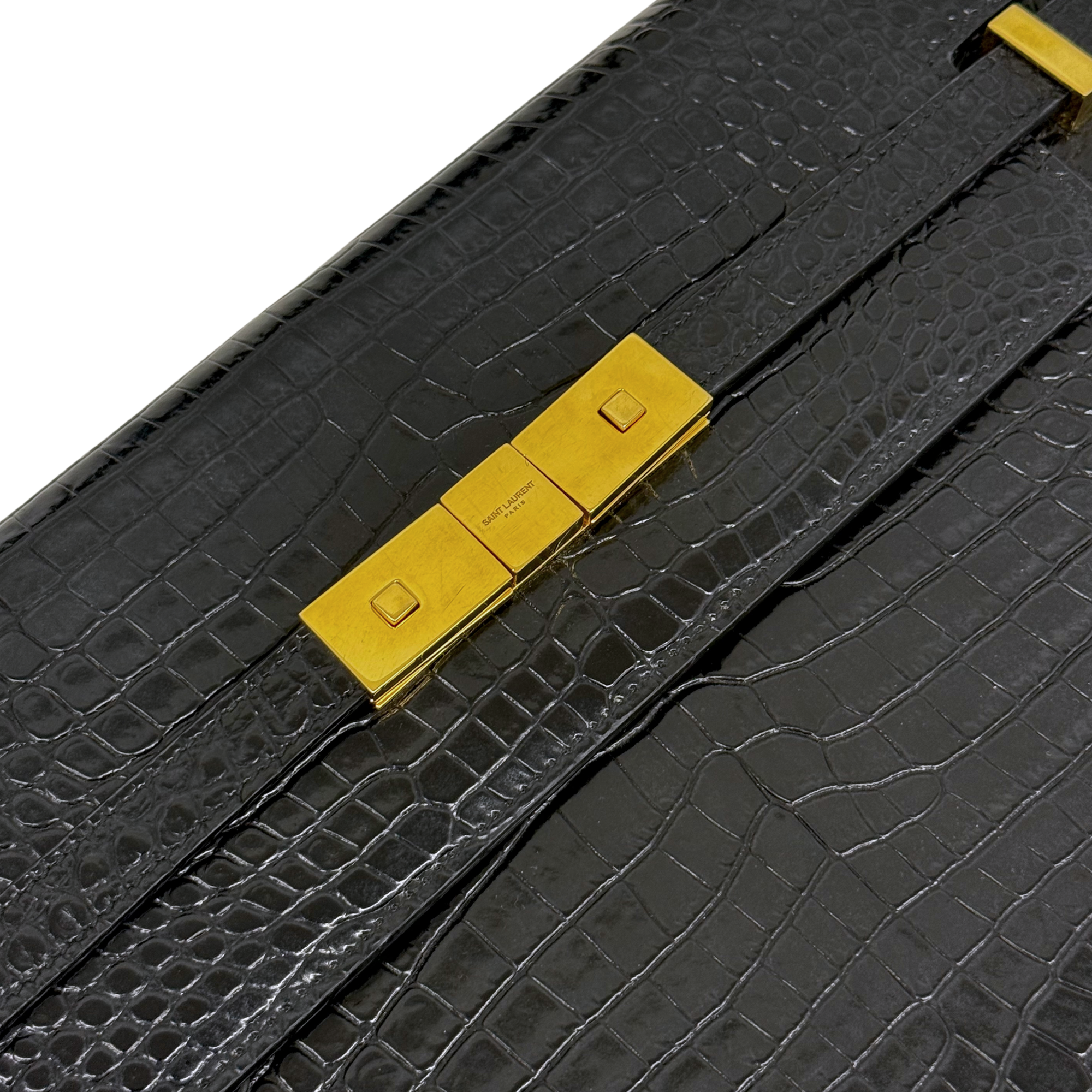 Black croc-embossed handbag with gold-tone front clasp hardware