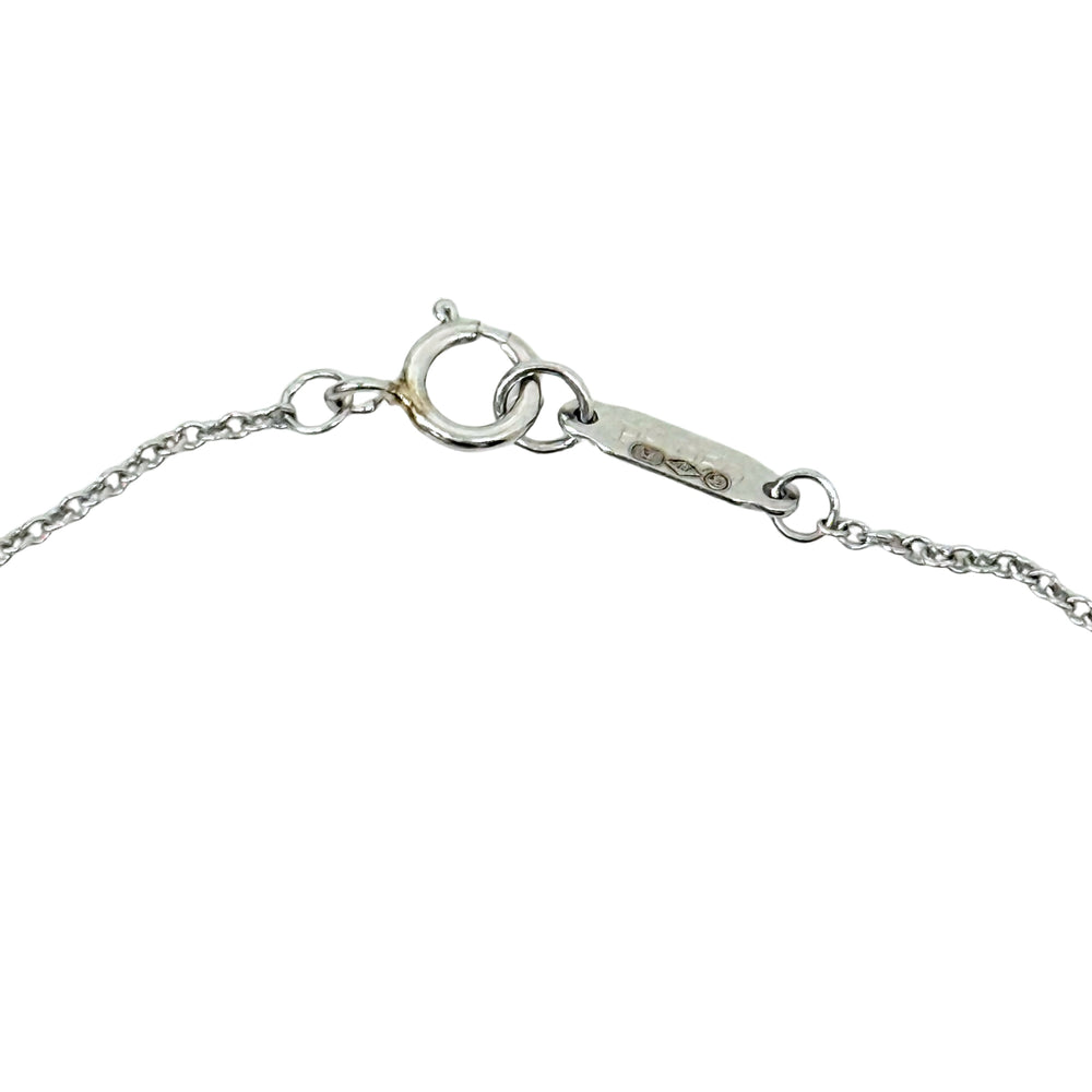 Silver-tone necklace chain clasp detail with small hallmark on spring-ring closure