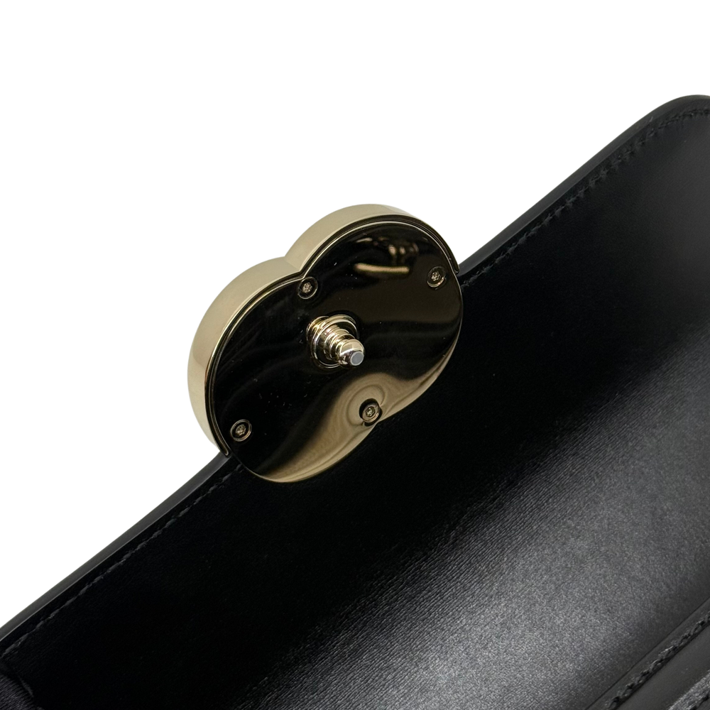 Black leather flap clasp with gold-tone hardware