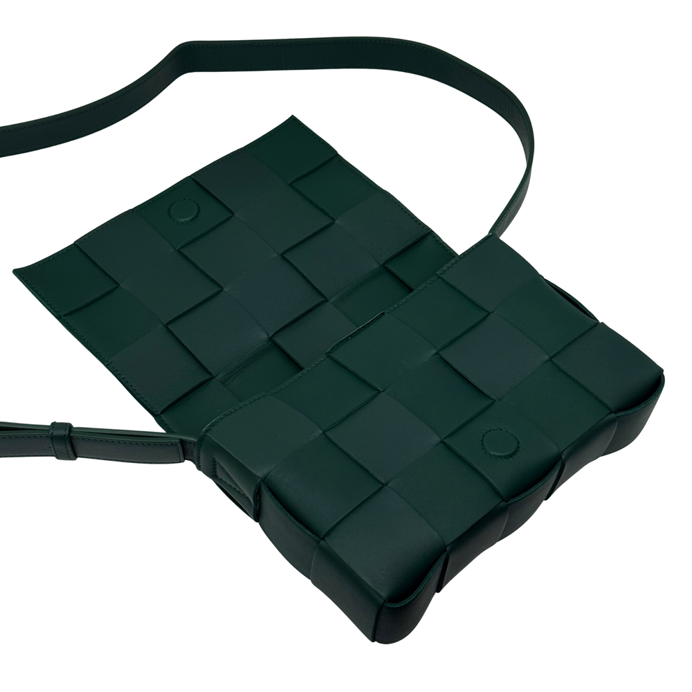 Green woven-leather shoulder bag with top handle and crossbody strap