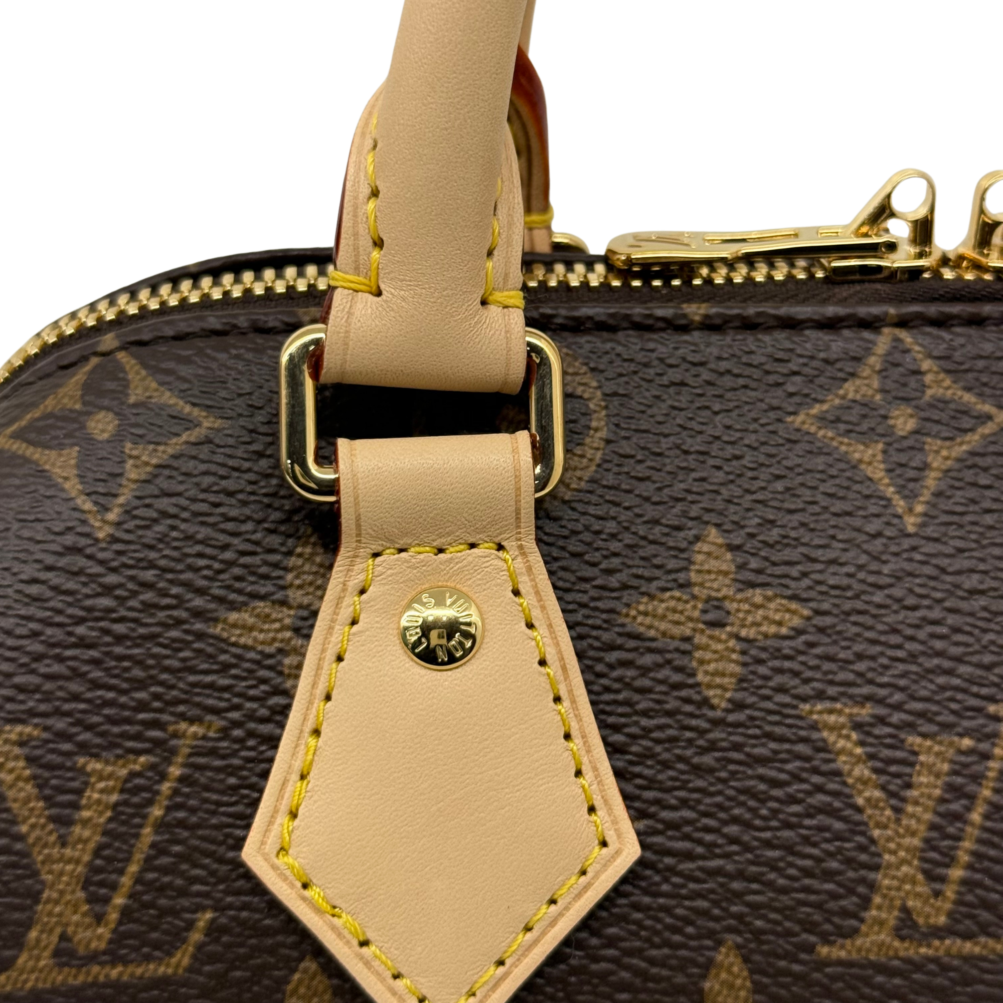 Louis Vuitton monogram handbag close-up of handle strap and gold tag