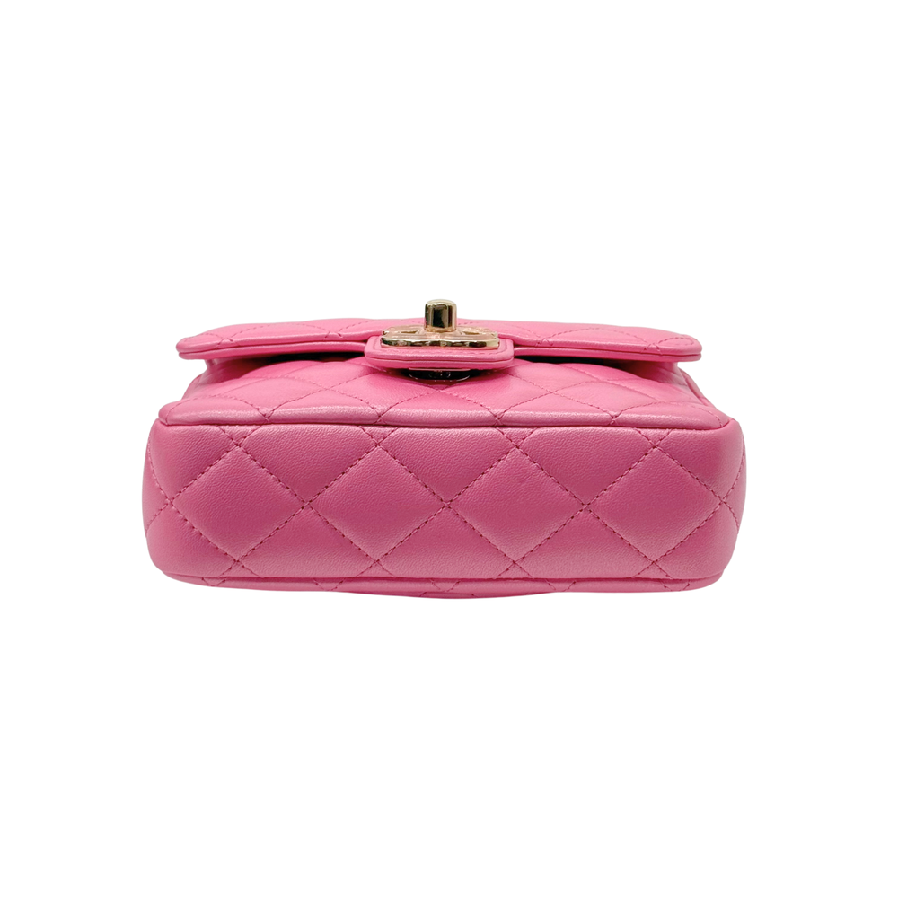 Pink quilted mini bag with gold turn-lock and short top handle