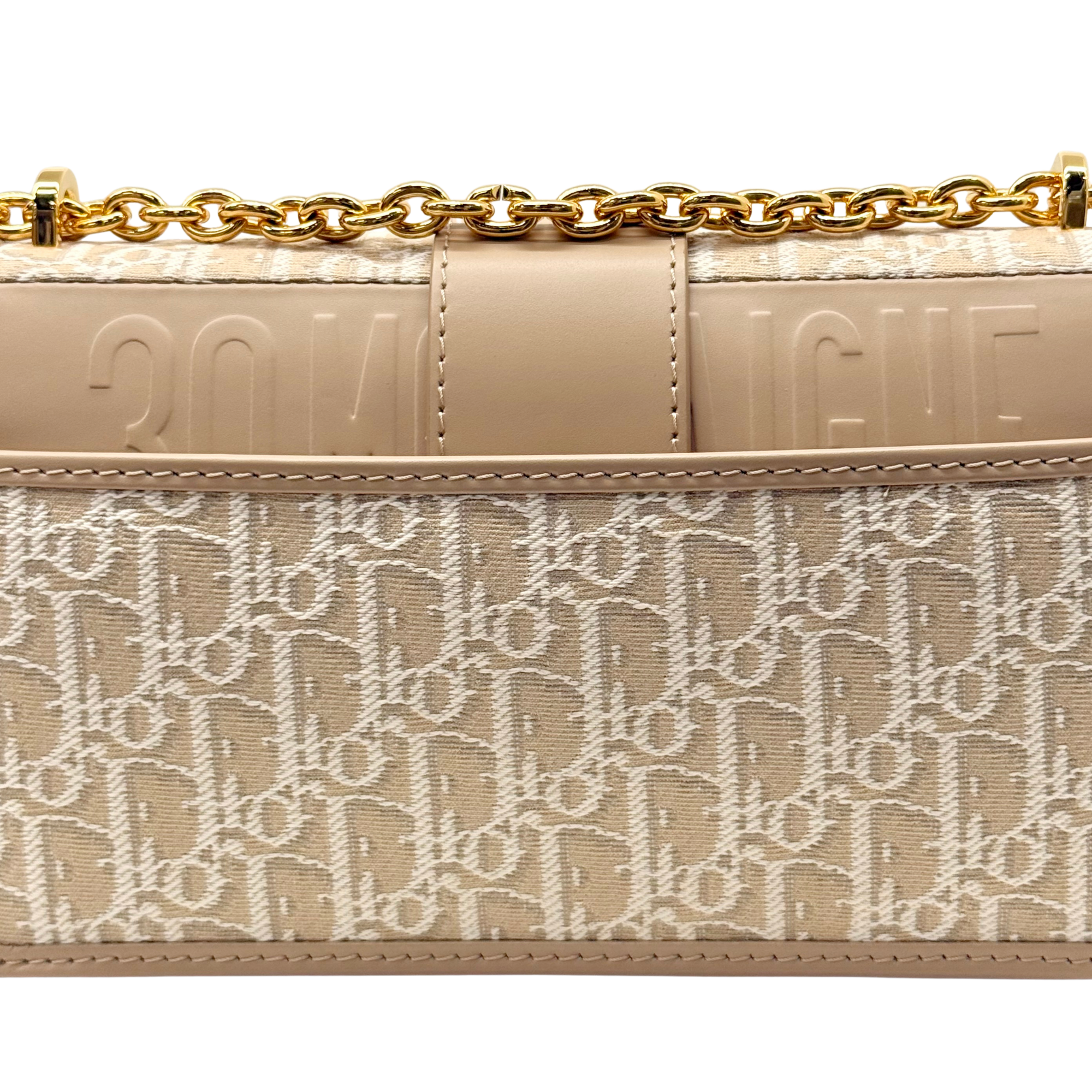 Pre-owned Dior mini bag close-up, beige leather panel with embossed 'Dior' details