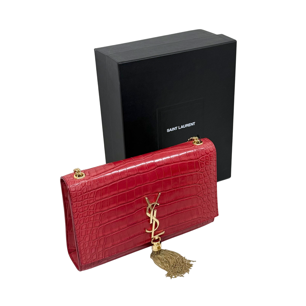 Red crocodile-textured YSL flap clutch with gold-tone chain and tassel charm