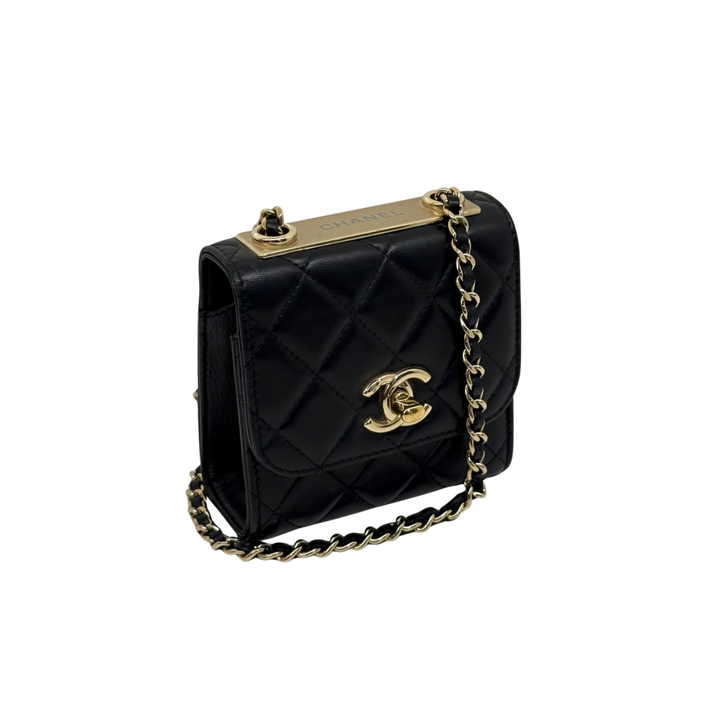 Black Chanel quilted mini flap bag with gold turn-lock posts and chain shoulder strap