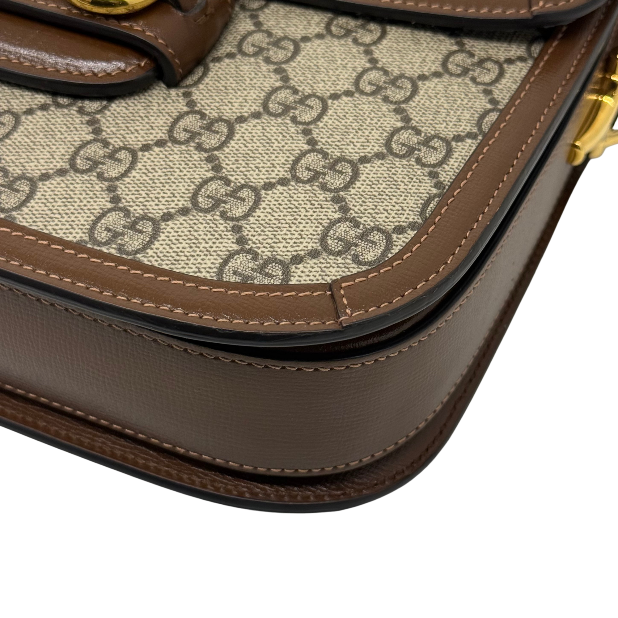 Pre-owned Gucci bag bottom edge with brown leather trim and GG canvas interior