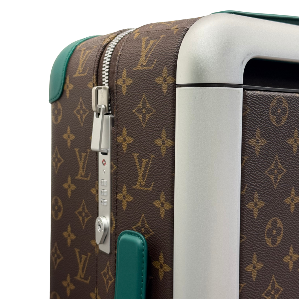 Pre-owned rolling suitcase side detail, silver zipper pull and teal leather trim