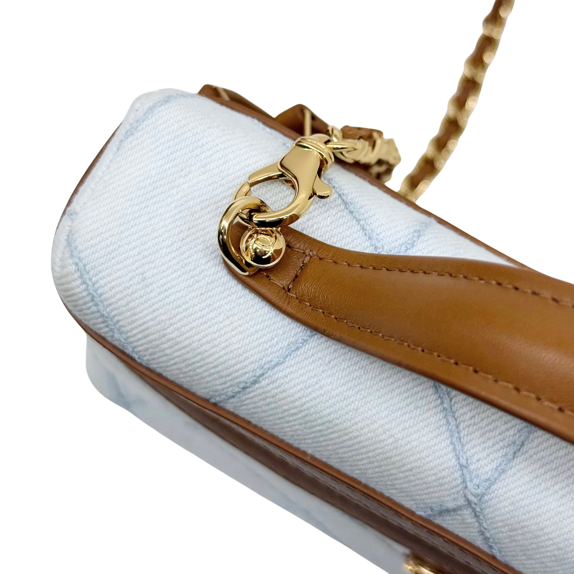 Chanel light-blue quilted side view with brown leather strap and gold-tone clasp
