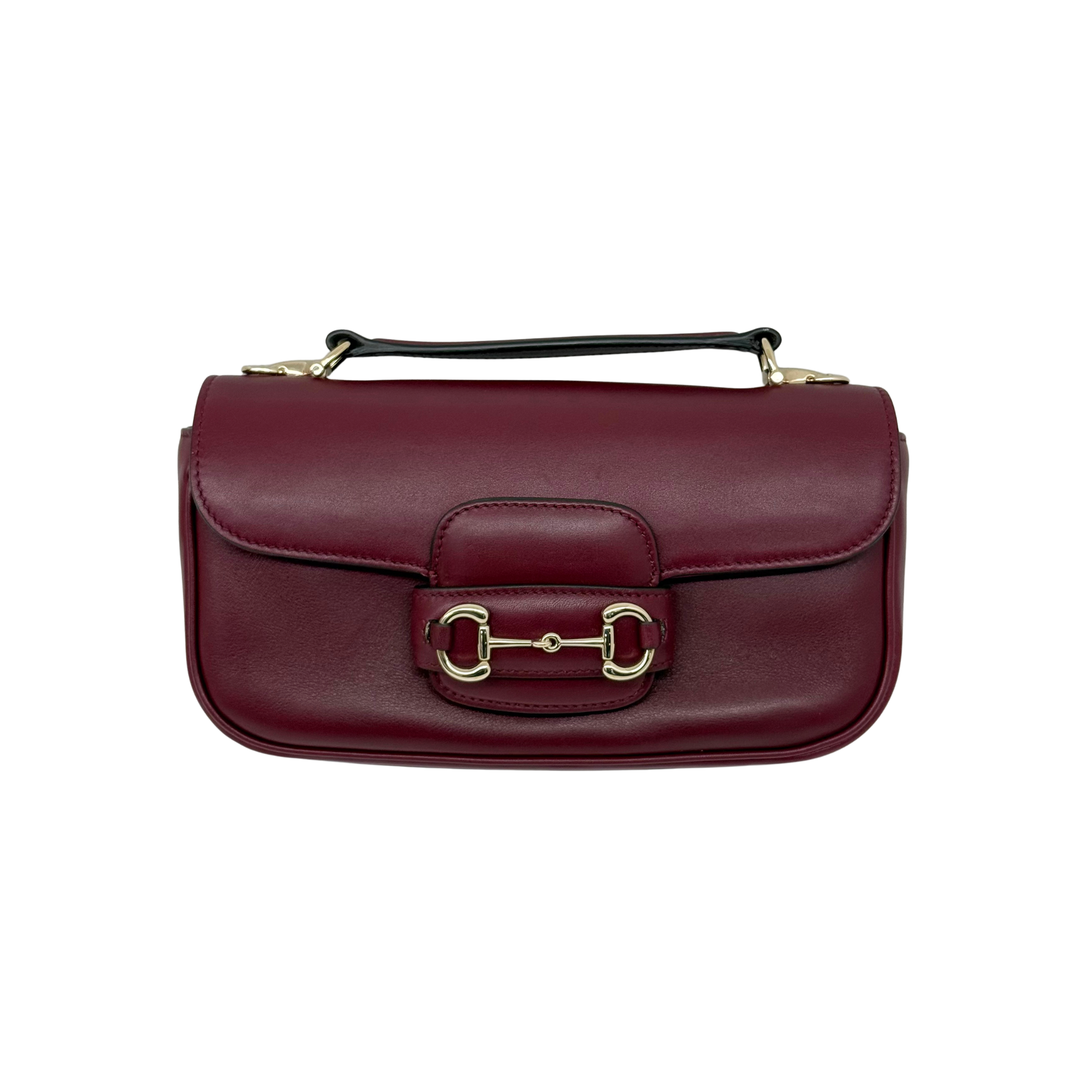 Maroon leather mini shoulder bag with top handle and front clasp