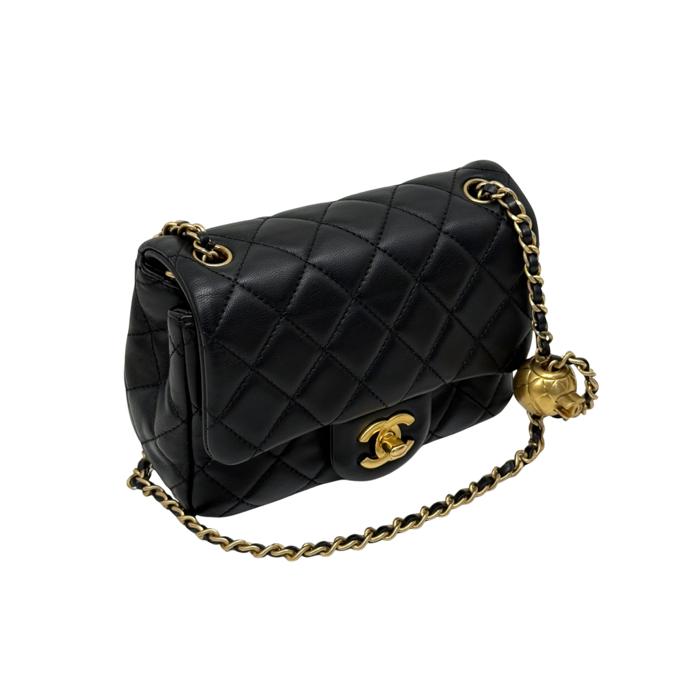 Black quilted shoulder bag with top flap, gold CC clasp and braided chain strap