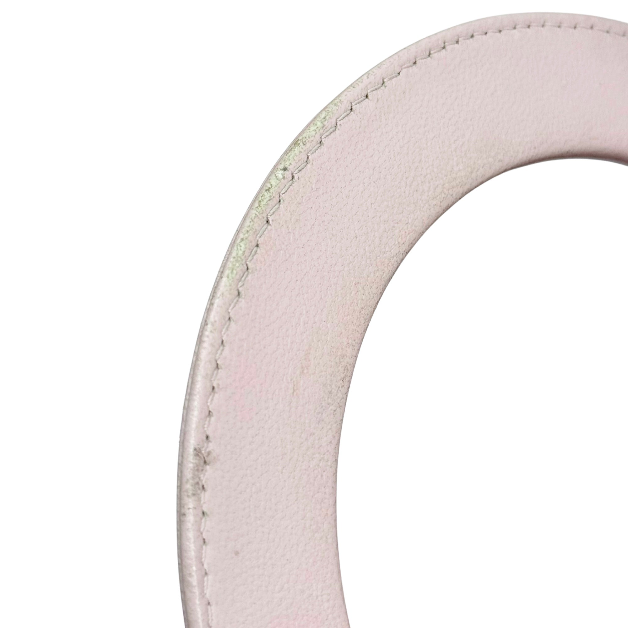 Pink leather tote bag handle with stitched edge and metal ring, for carrying