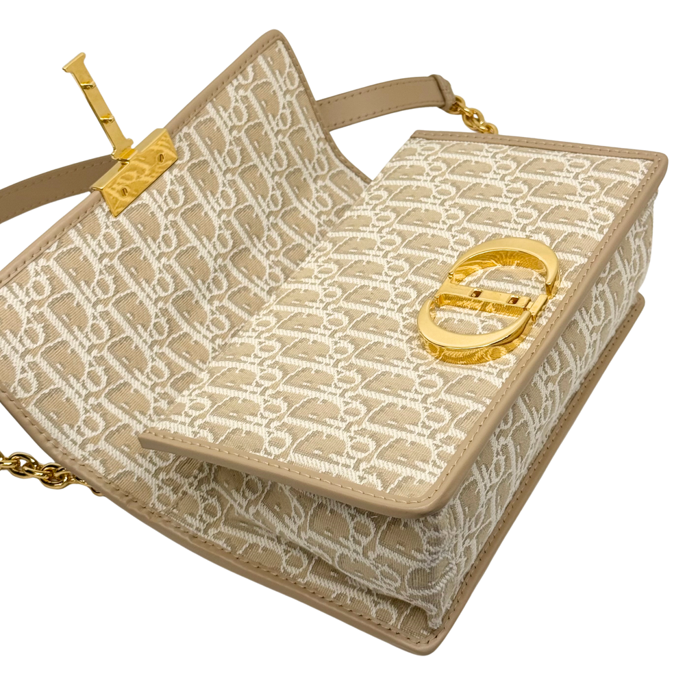 Dior pre-owned small tote-style bag with beige monogram canvas and gold top emblem