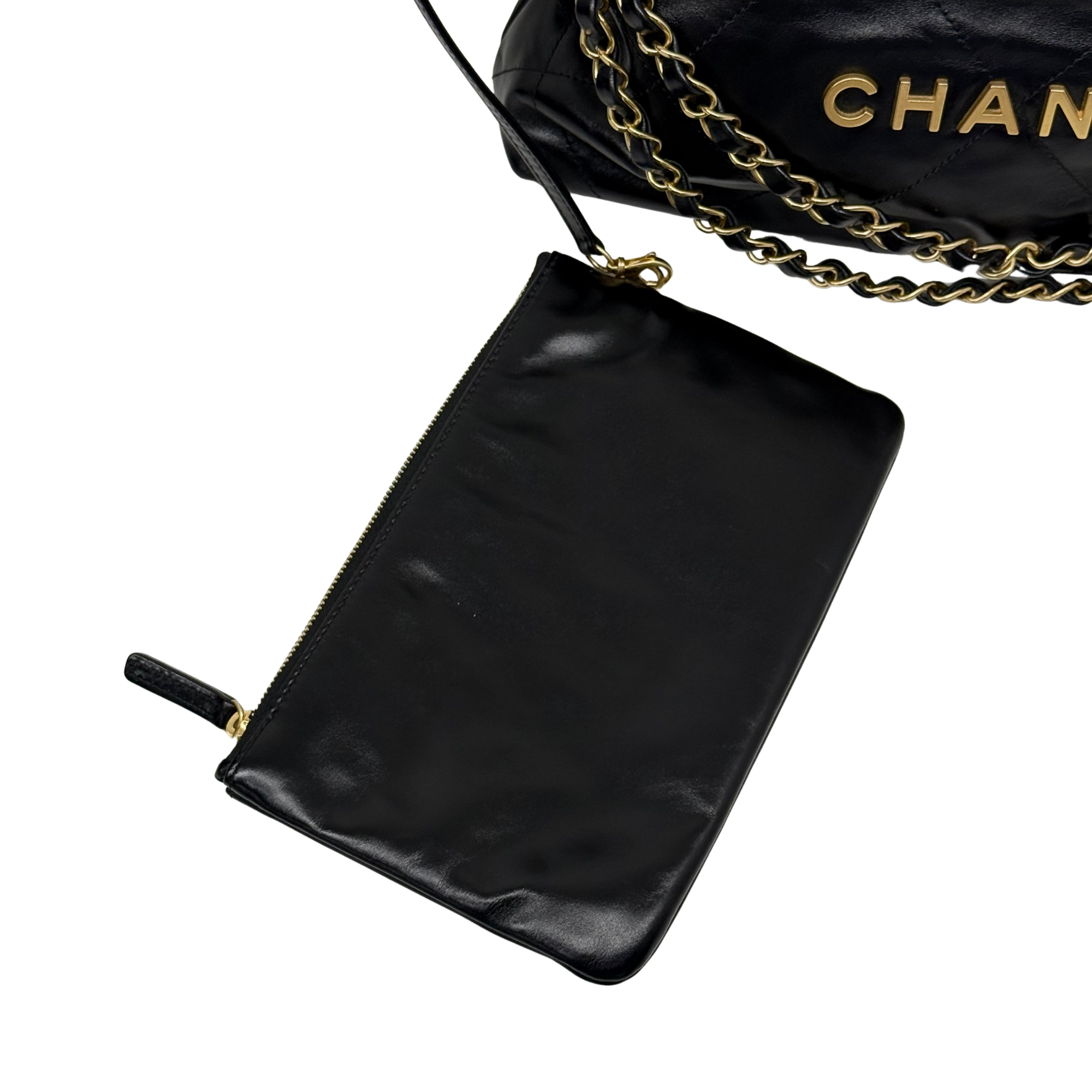 Black leather clutch/wristlet with gold zipper and chain strap; Chanel logo on back