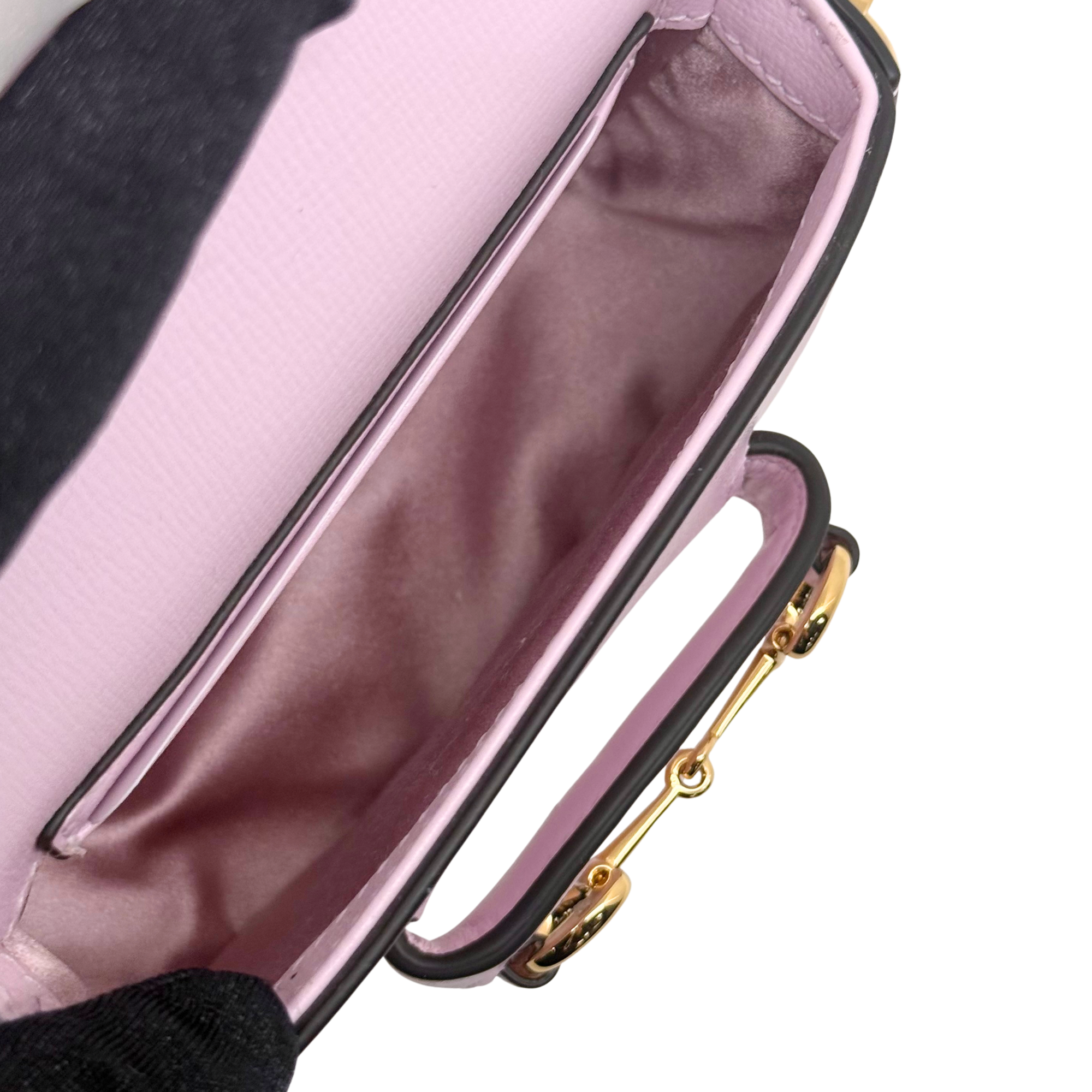 Pink Gucci mini bag interior lining with open top and chain strap hardware