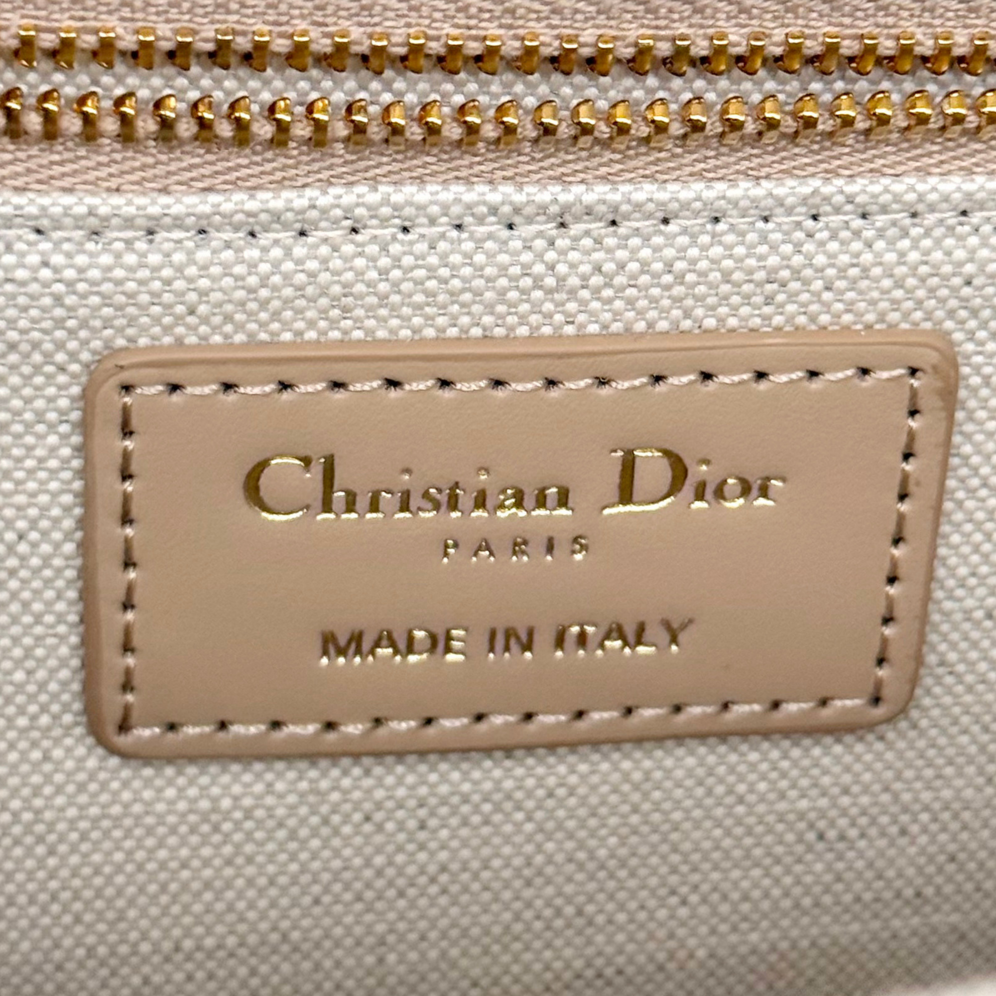 Dior pre-owned bag interior label with "Christian Dior" and "Made in Italy"