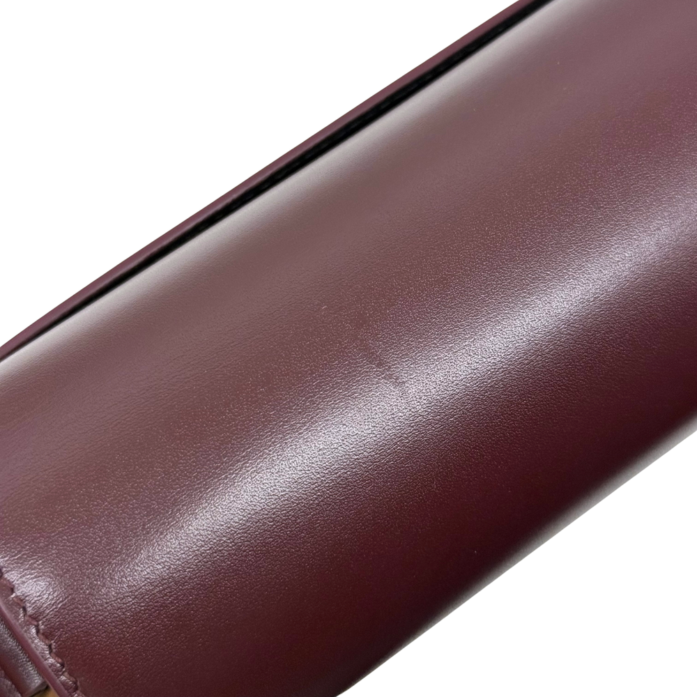 Saint Laurent Le 61 Besace bag close-up of smooth burgundy leather strap edge