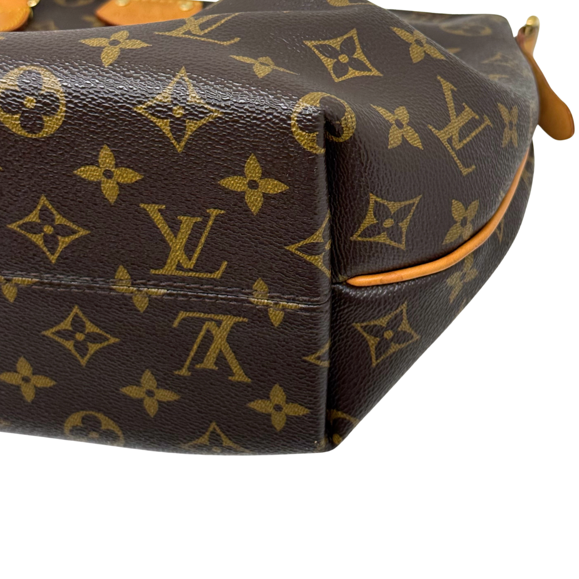 Louis Vuitton monogram handbag corner with leather trim and handle loop