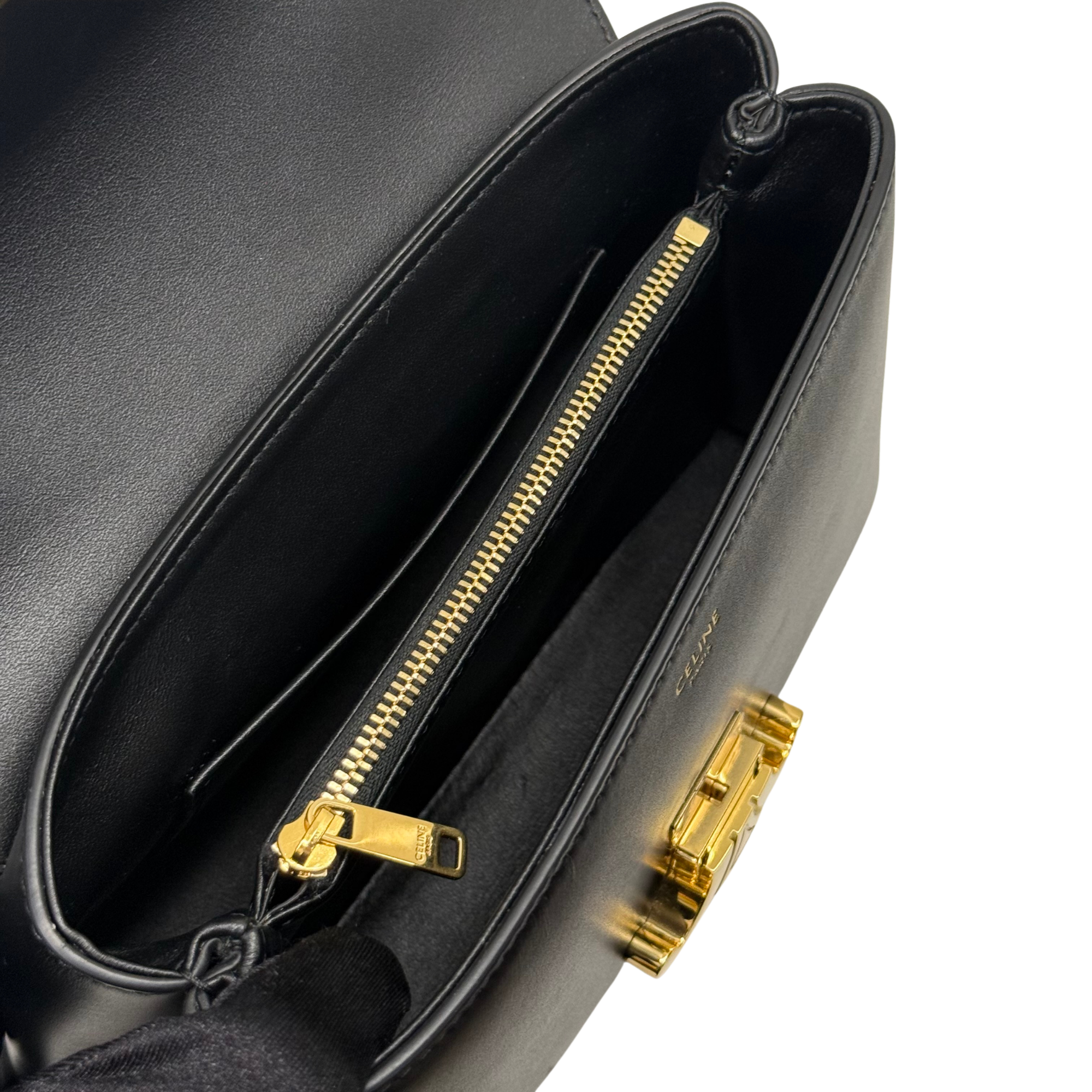 Black leather interior view with gold zipper and detachable strap hardware