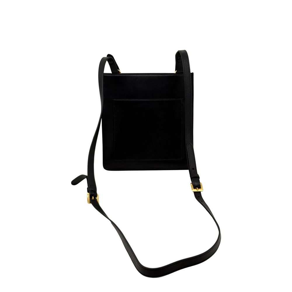 Black mini crossbody bag with top handles, adjustable strap, and gold-toned buckles