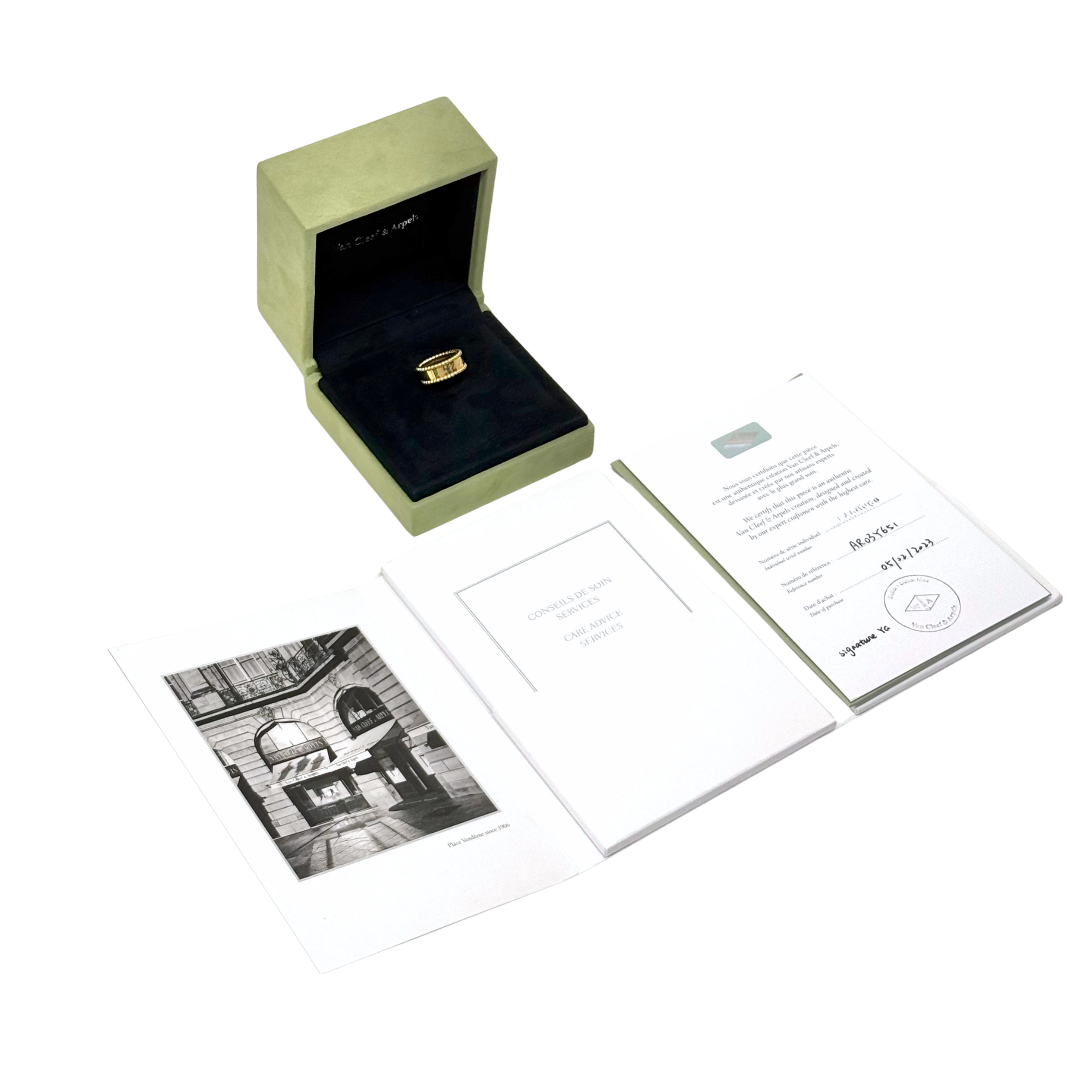 Gold-tone Van Cleef & Arpels ring in box with paperwork