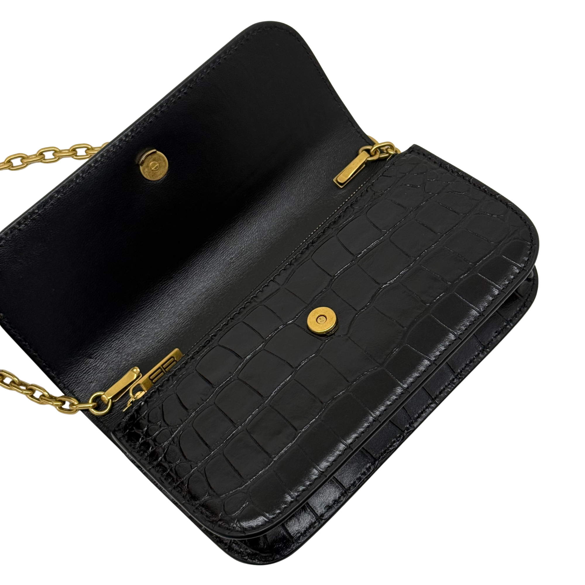 Black croc-embossed shoulder bag with gold chain, front flap buttons, and stitching