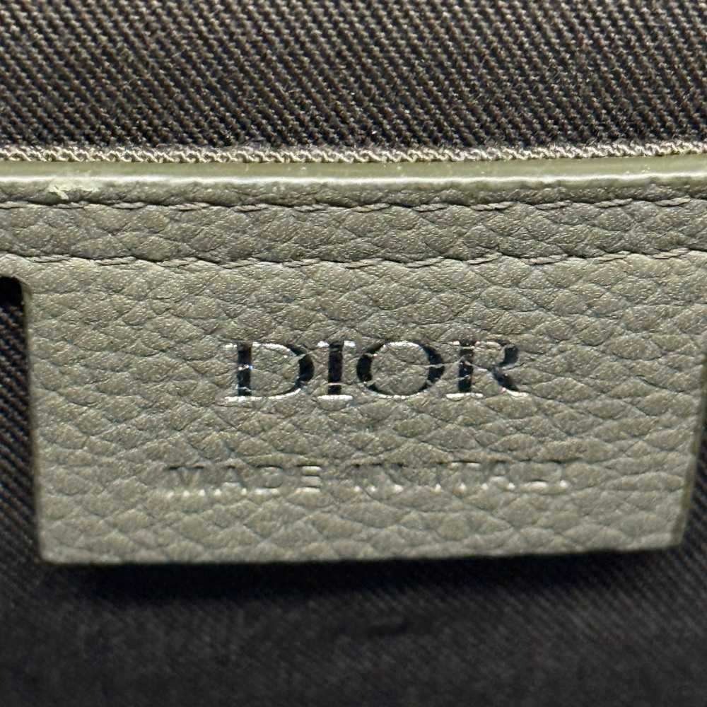 Dior logo patch on light olive leather tab with stitched edge