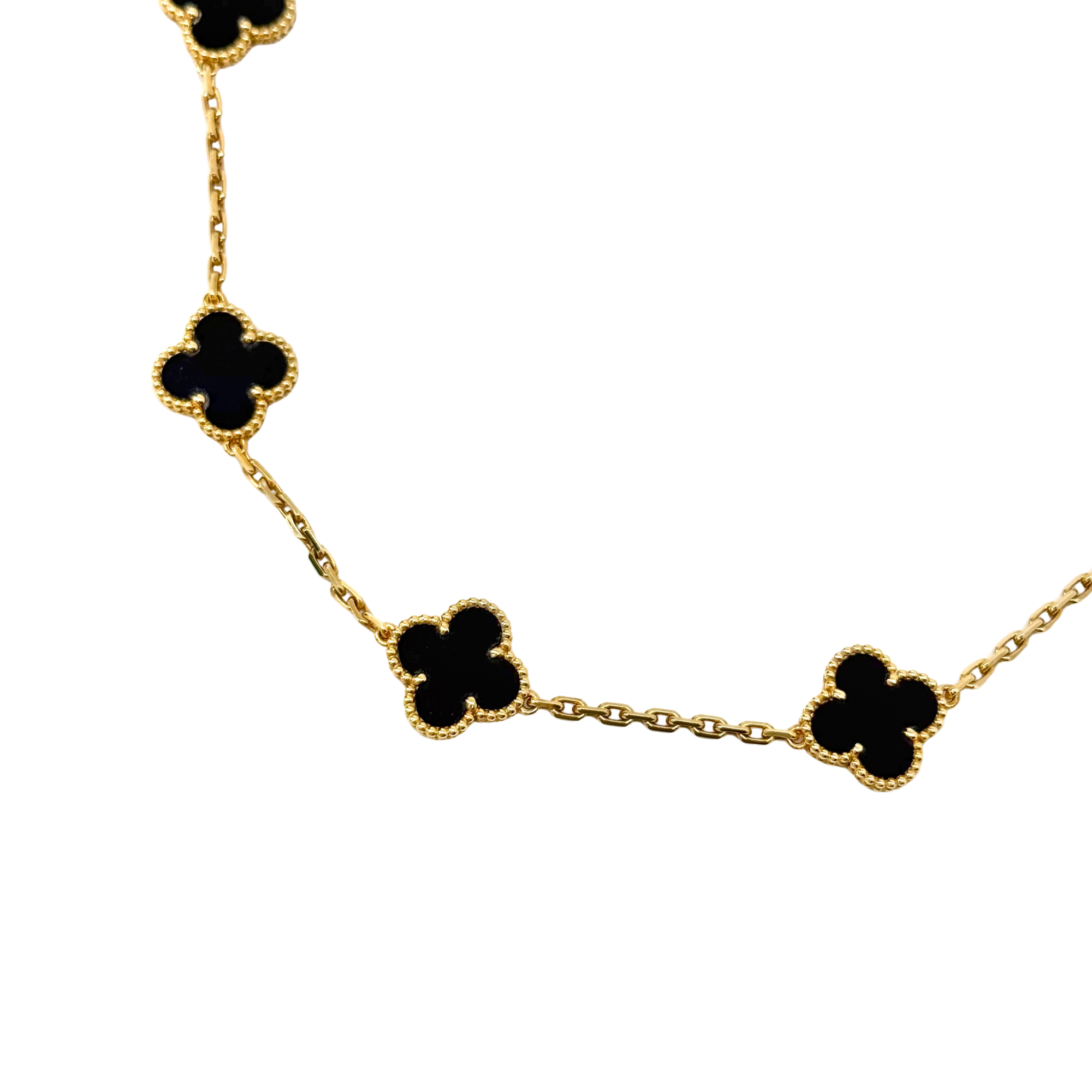 Van Cleef clover necklace partial view with gold-tone links and black motif charms