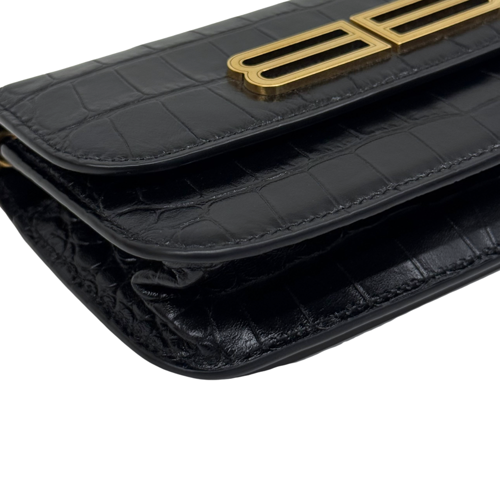 Black croc-embossed leather flap with gold B logo and stacked stitched edge detail.