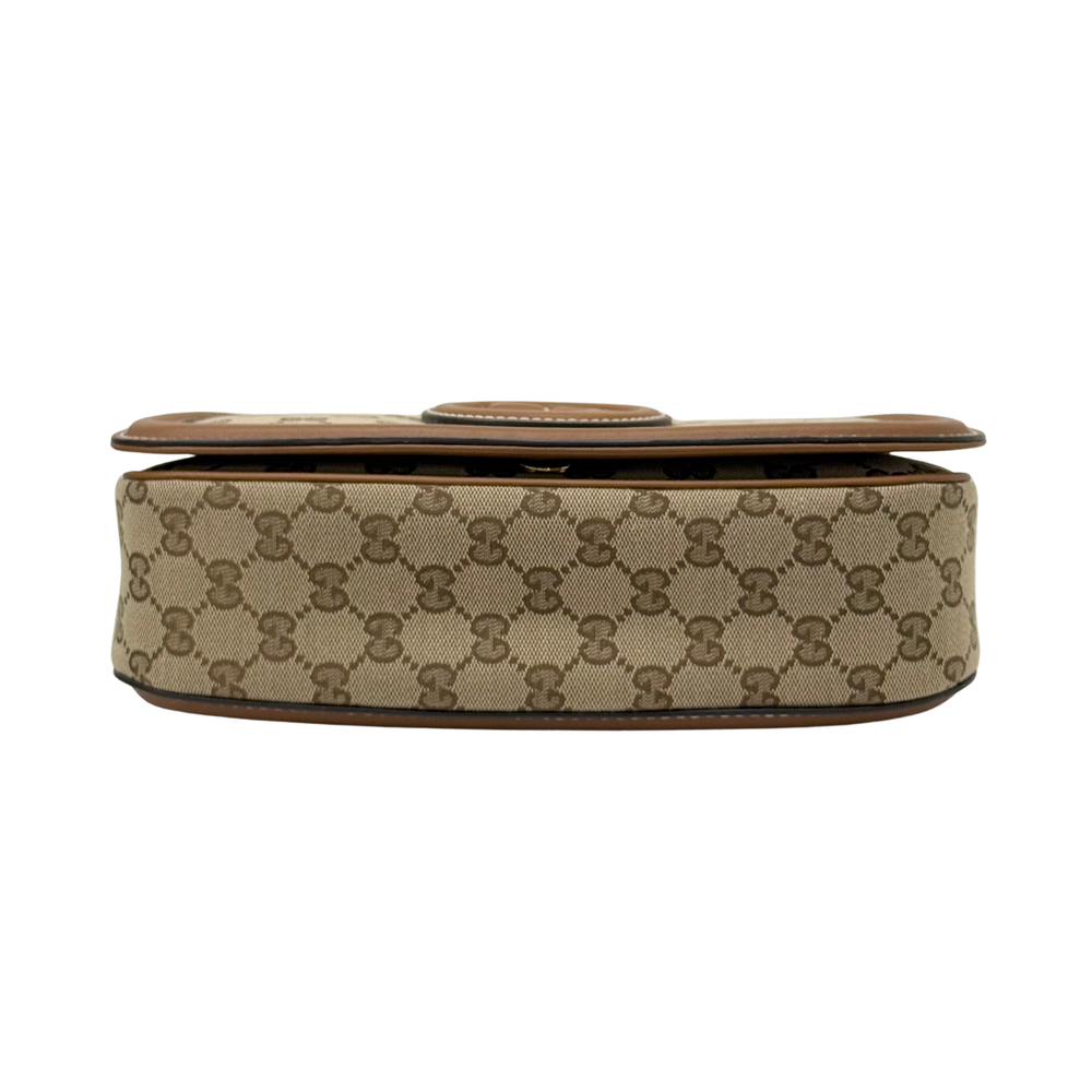 Gucci GG canvas mini bag side view with brown leather base and trim