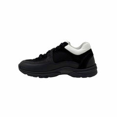 Black low-top sneakers with white heel tab, lace-up front, thick rubber sole.