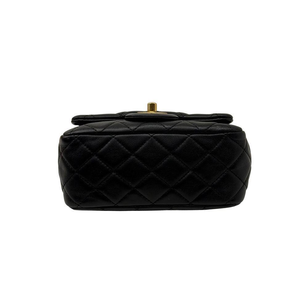 Pre-owned quilted shoulder bag back view in black leather with diamond stitching and gold top knob