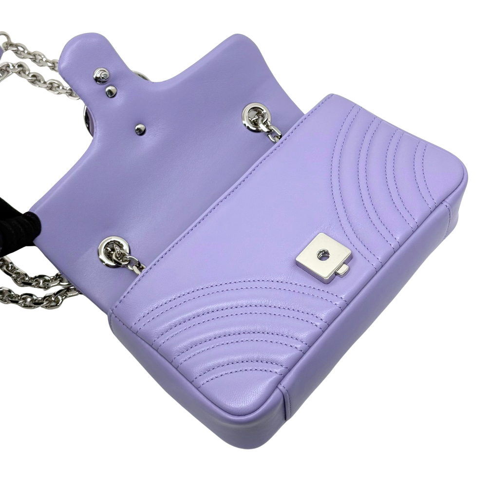 Lavender mini flap bag with silver chain, snap hardware, and quilted front panel