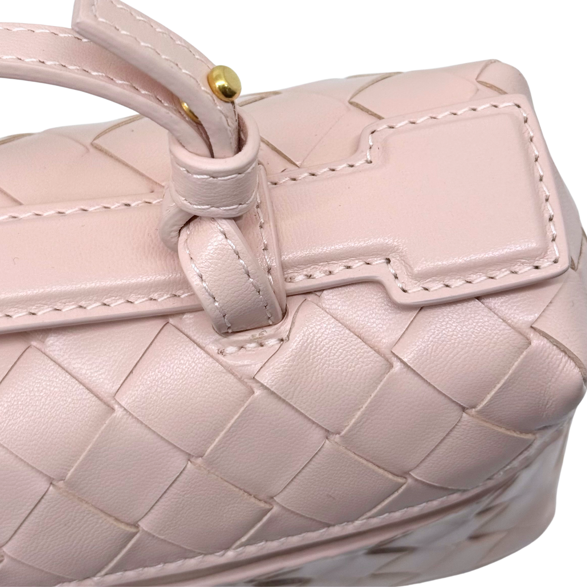 Bottega Veneta pink leather bag detail with braided strap and gold hardware