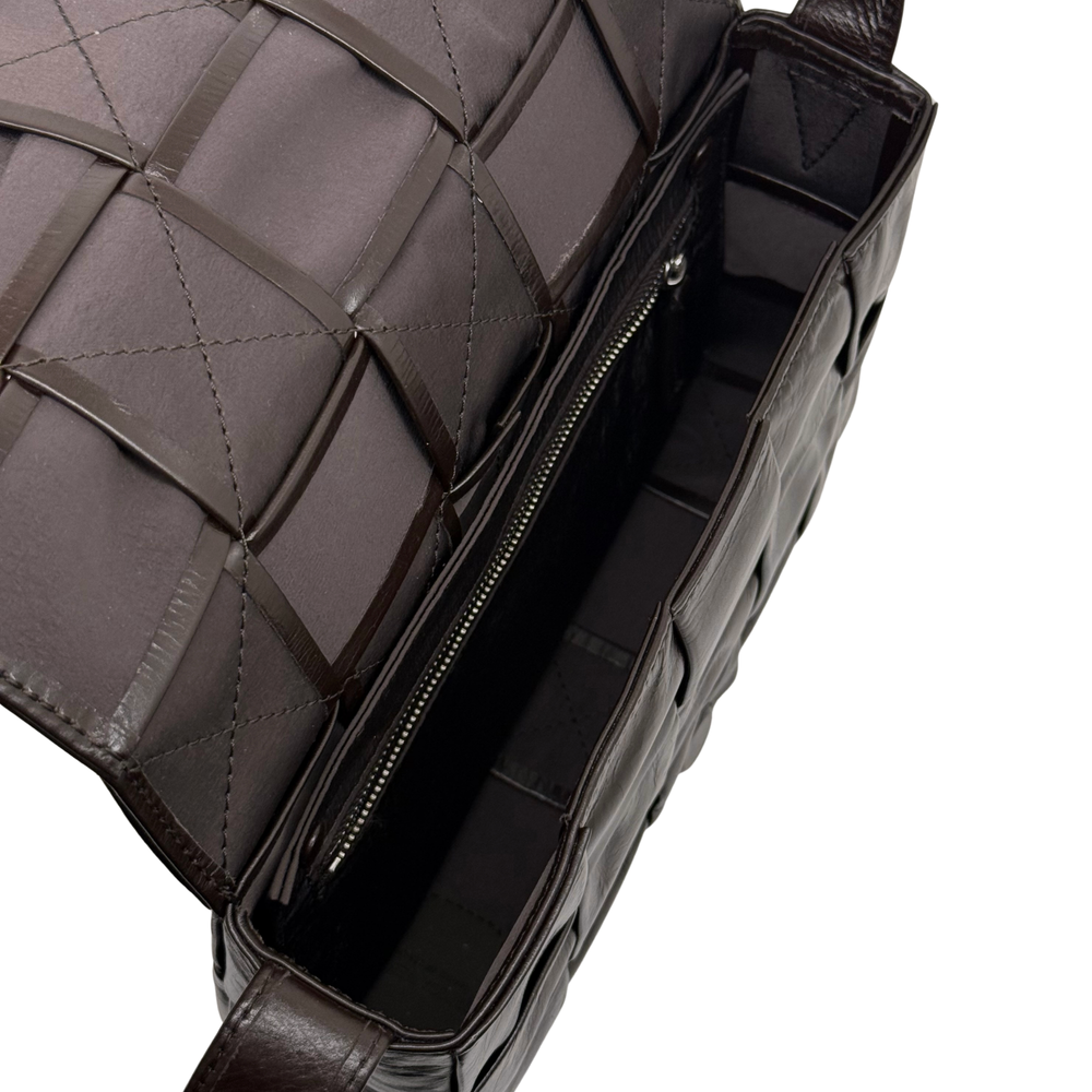Bottega quilted bag with dark zipper opening, lined interior, and braided strap