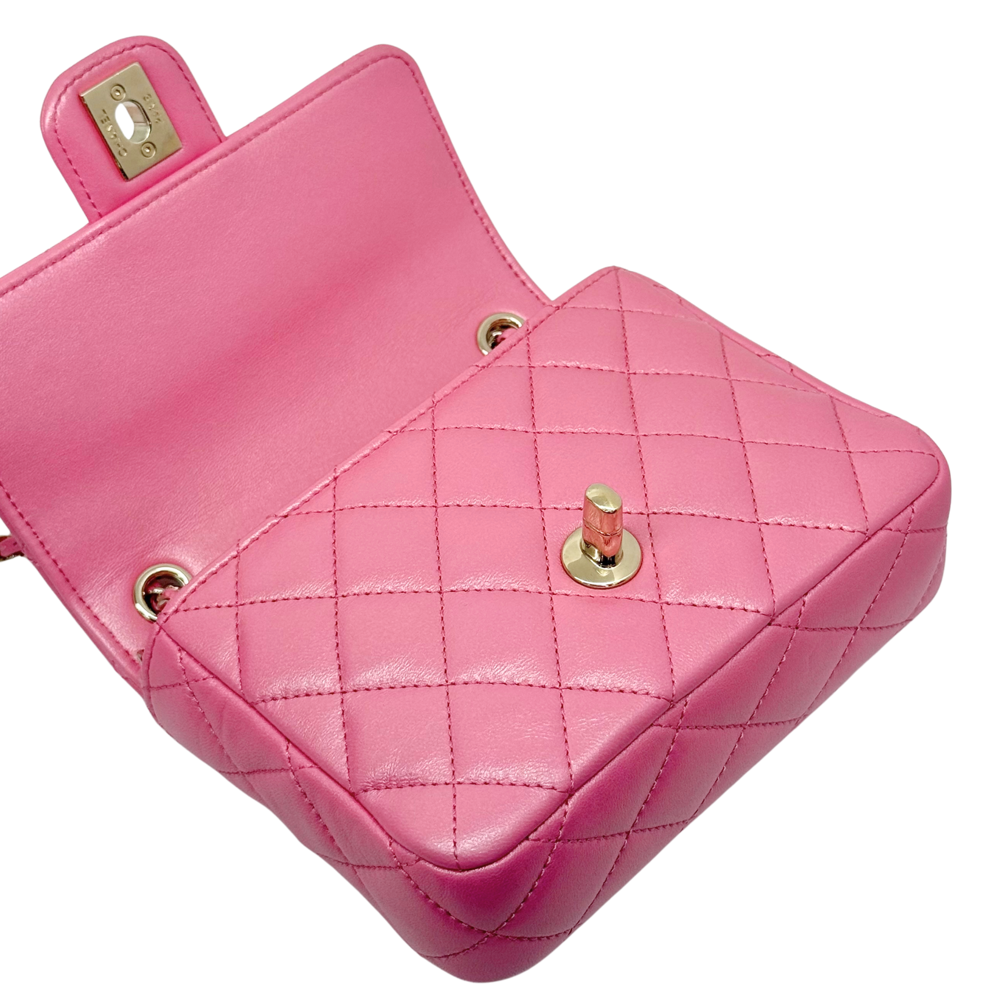 Pink quilted mini bag with gold turn-lock and chain strap ring