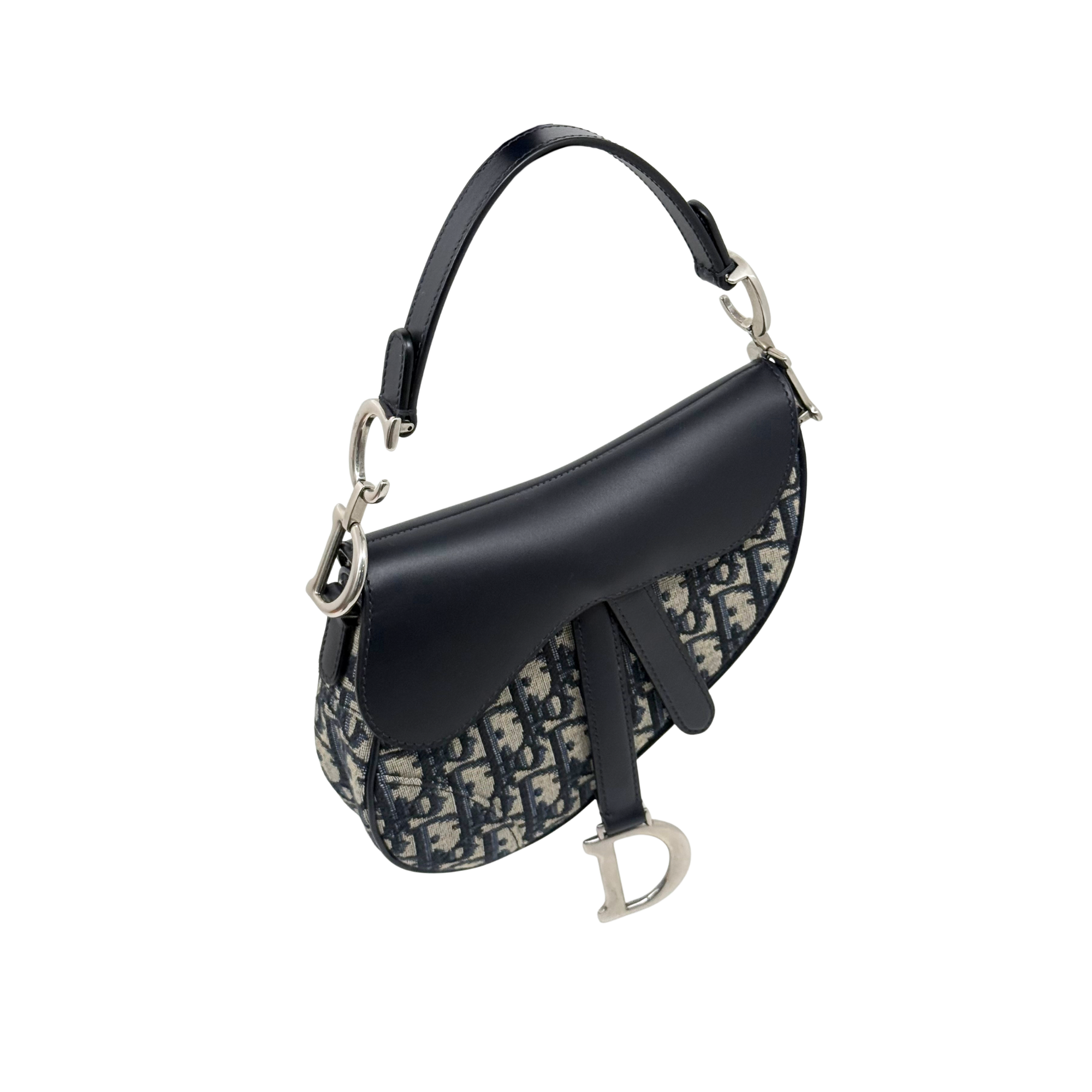 Pre-owned Dior mini saddle bag angled view with black leather flap and monogram canvas