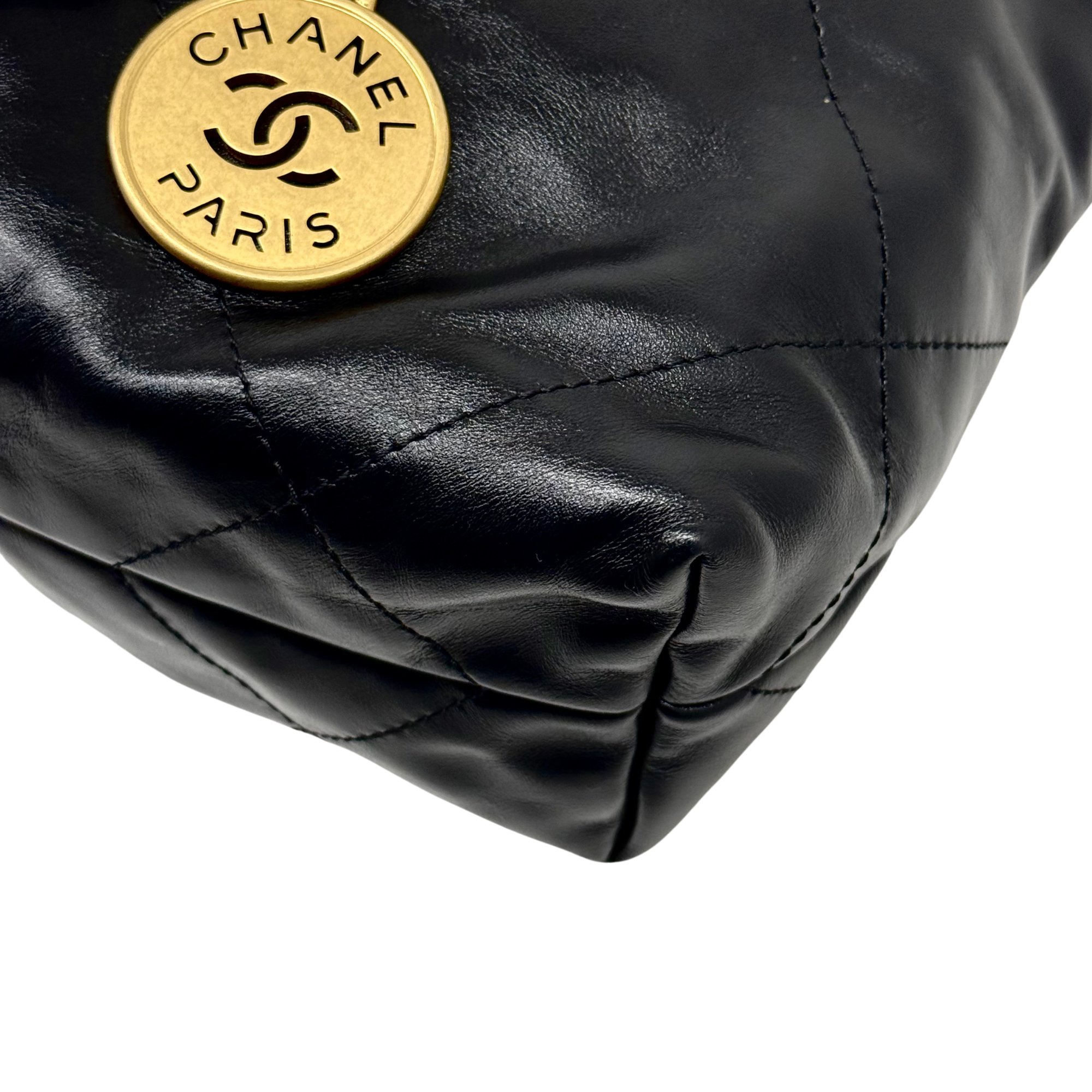 Black quilted leather bag corner with CHANEL PARIS round gold seal hardware