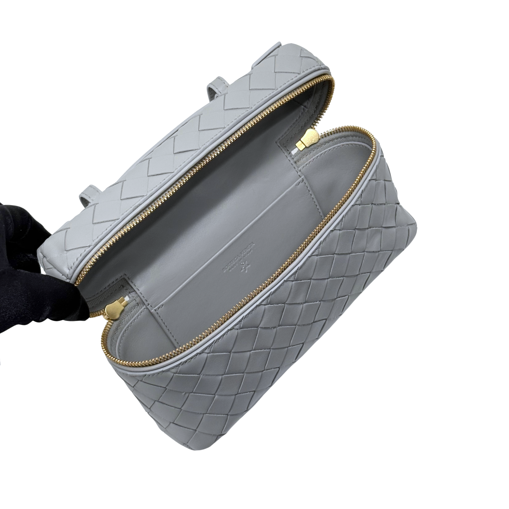 Bottega Veneta gray leather zip pouch style bag with gold zipper and short carry handle.