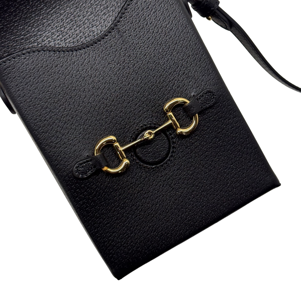 Gucci black leather mini crossbody bag with gold clasp and embossed logo front