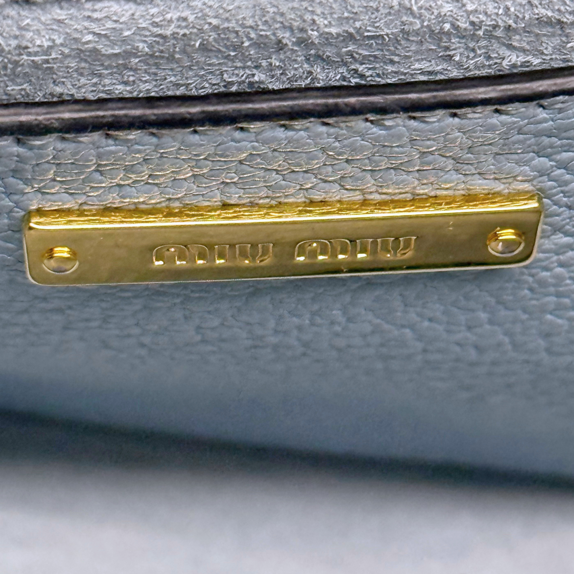 Pre-owned Miu Miu bag hardware logo plate, gold on light blue