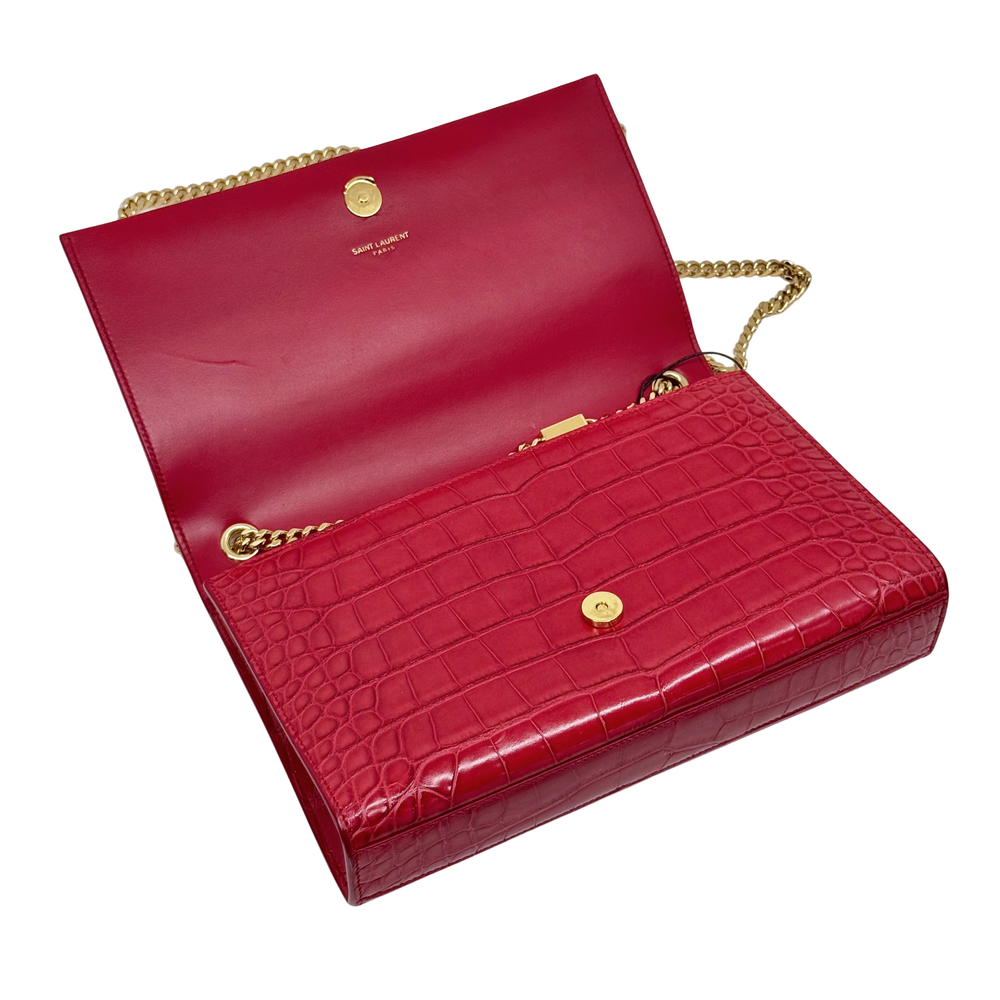 Red croc-embossed flap clutch with gold chain, centered YSL logo, and tassel