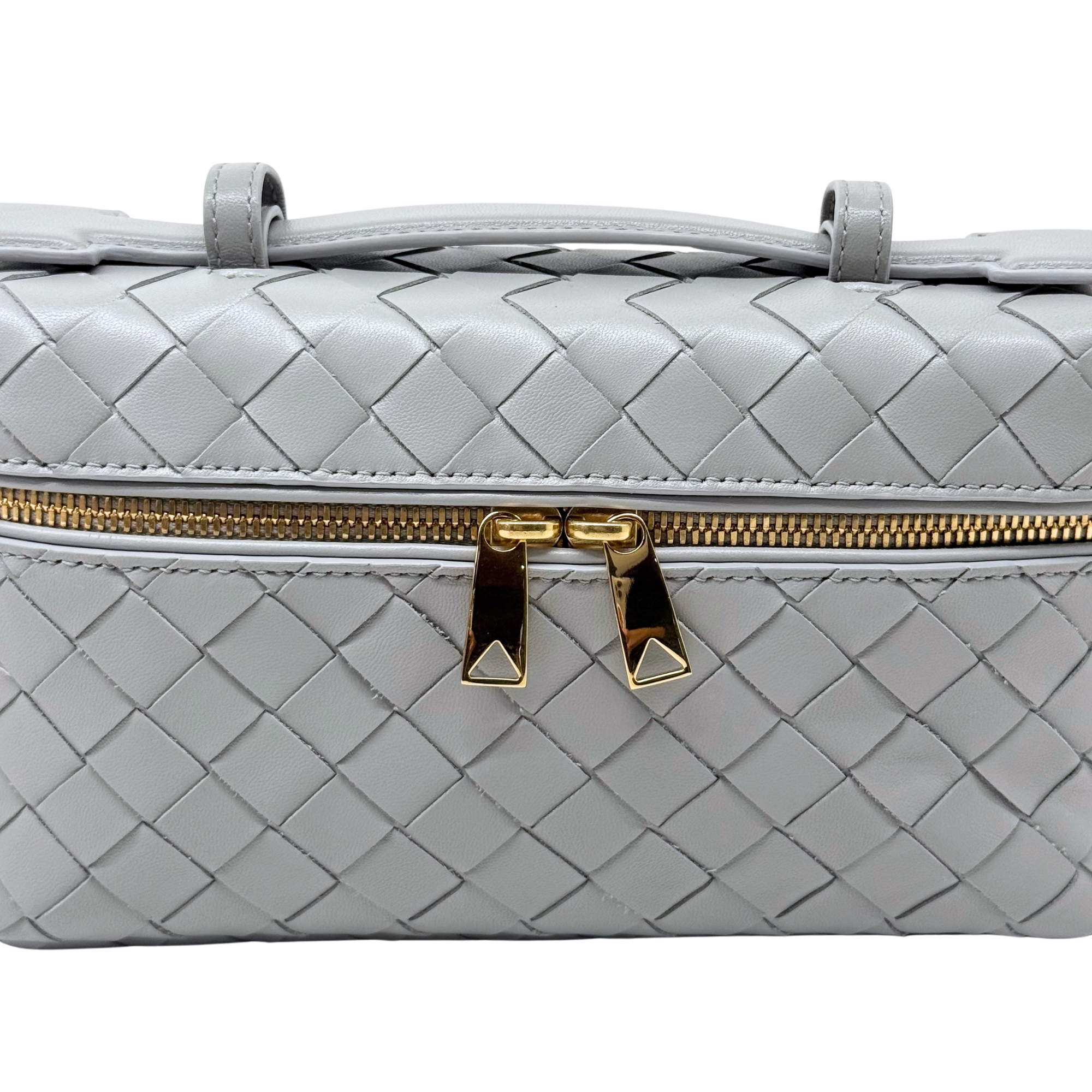 Bottega Veneta quilted leather bag close-up, light gray, gold zipper pull