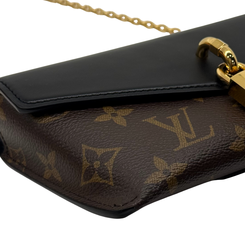 Brown monogram canvas bag with black flap edge and gold-tone clasp