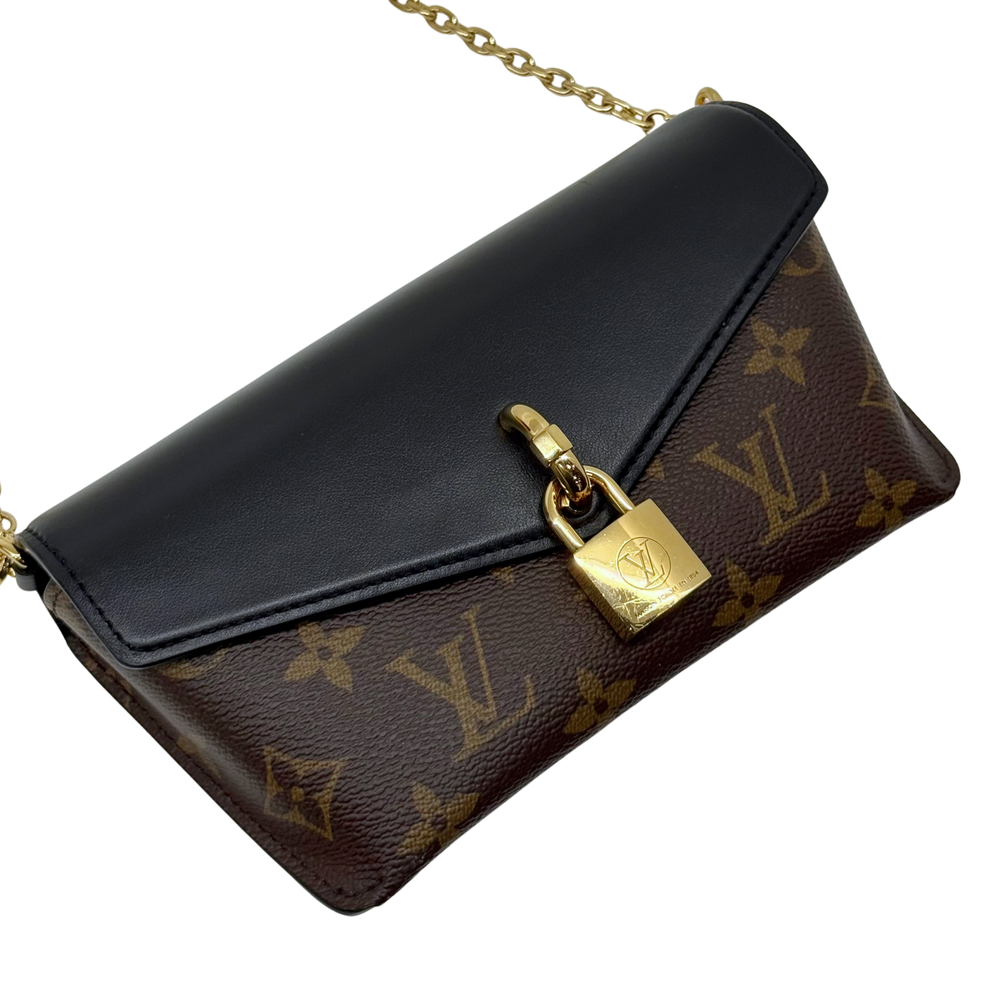 Brown monogram crossbody bag with black leather flap and gold-tone clasp