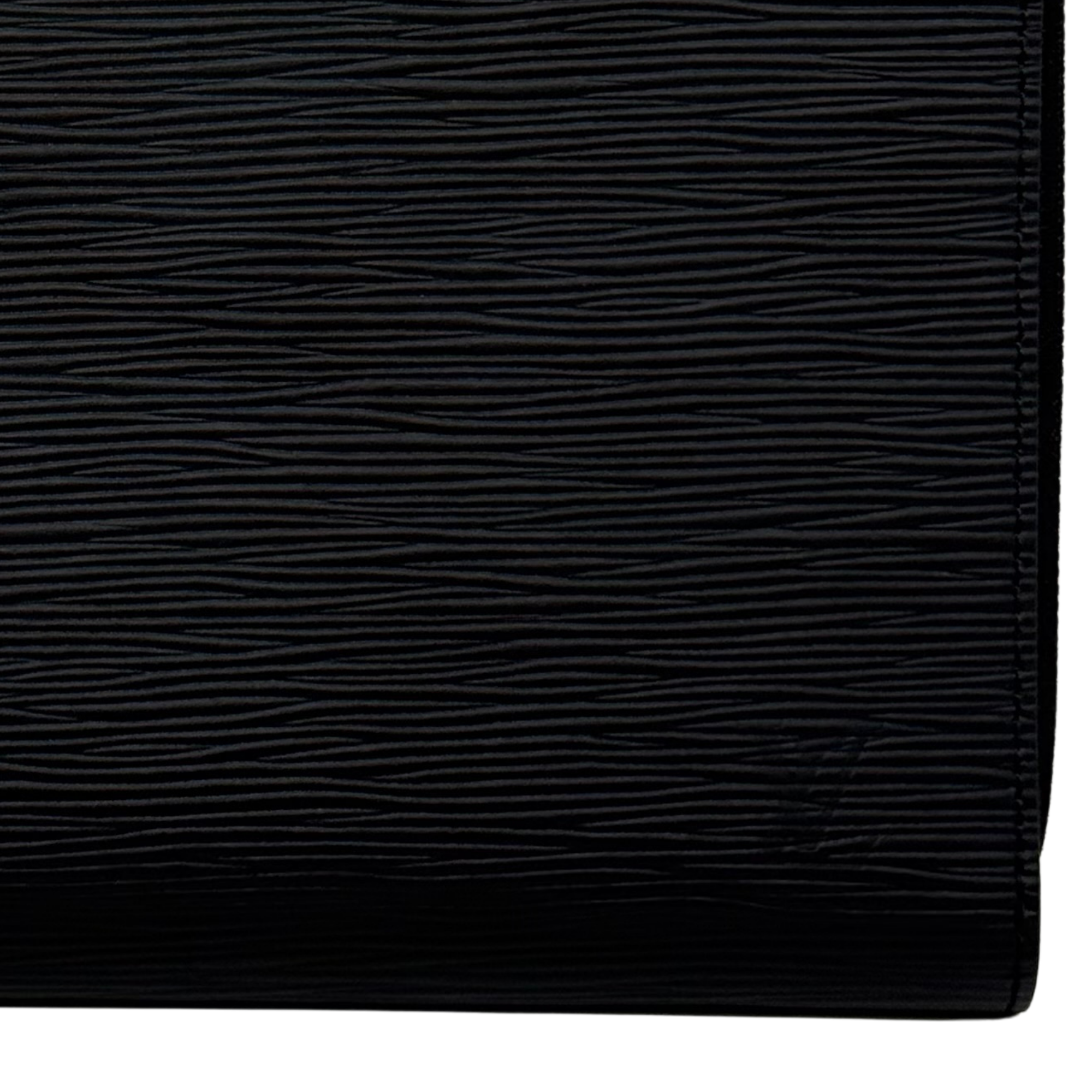 Louis Vuitton black leather wallet close-up showing textured grain and stitched trim