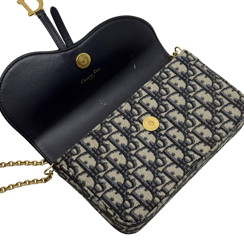 Dior monogram crossbody bag with black leather interior pocket and gold chain strap