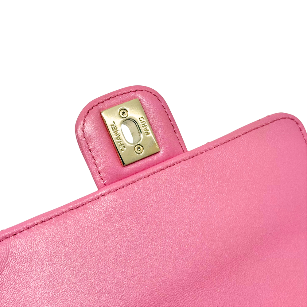 Gold Chanel authenticity label on pink leather lining near flap edge