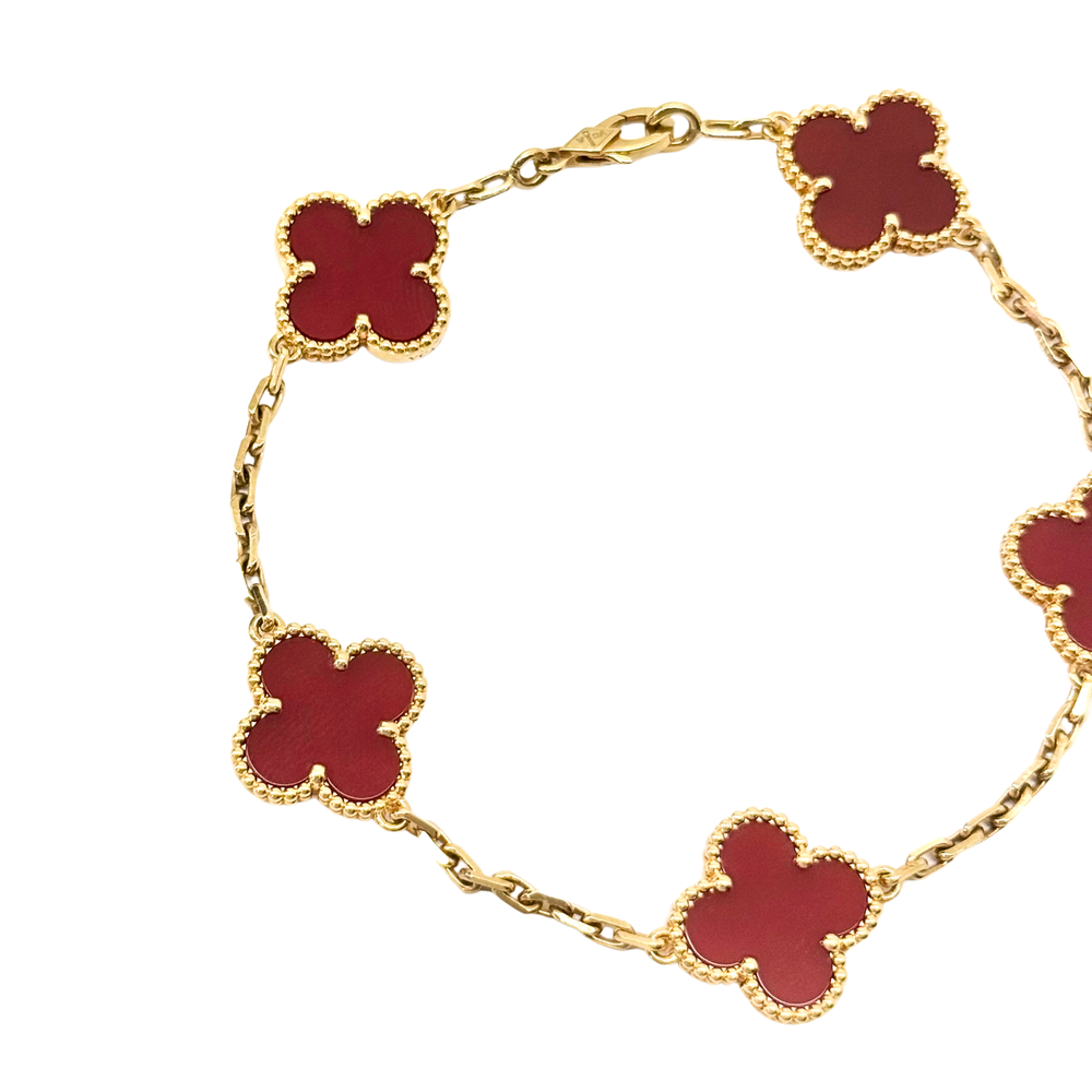 Goldtone bracelet with red clover links and goldtone chain, angled view